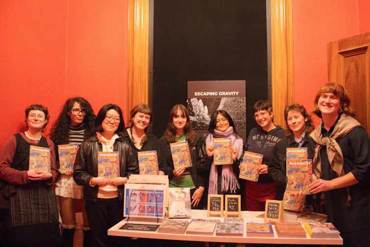 Young people holding copies of the magazine, Vocieworks.