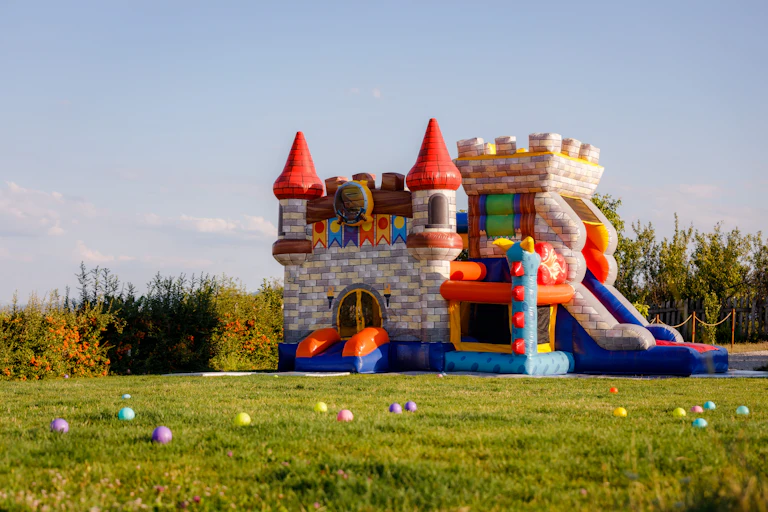 An inflatable castle on a grassy field