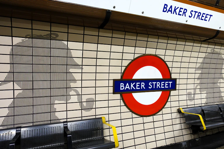 Silhouette motifs of Sherlock Holmes on the platform of Baker Street London Underground station.