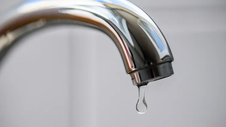 silver tap dripping with water