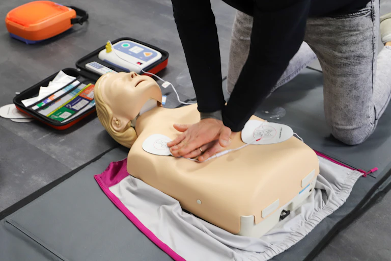 CPR being performed on a first aid mannequin