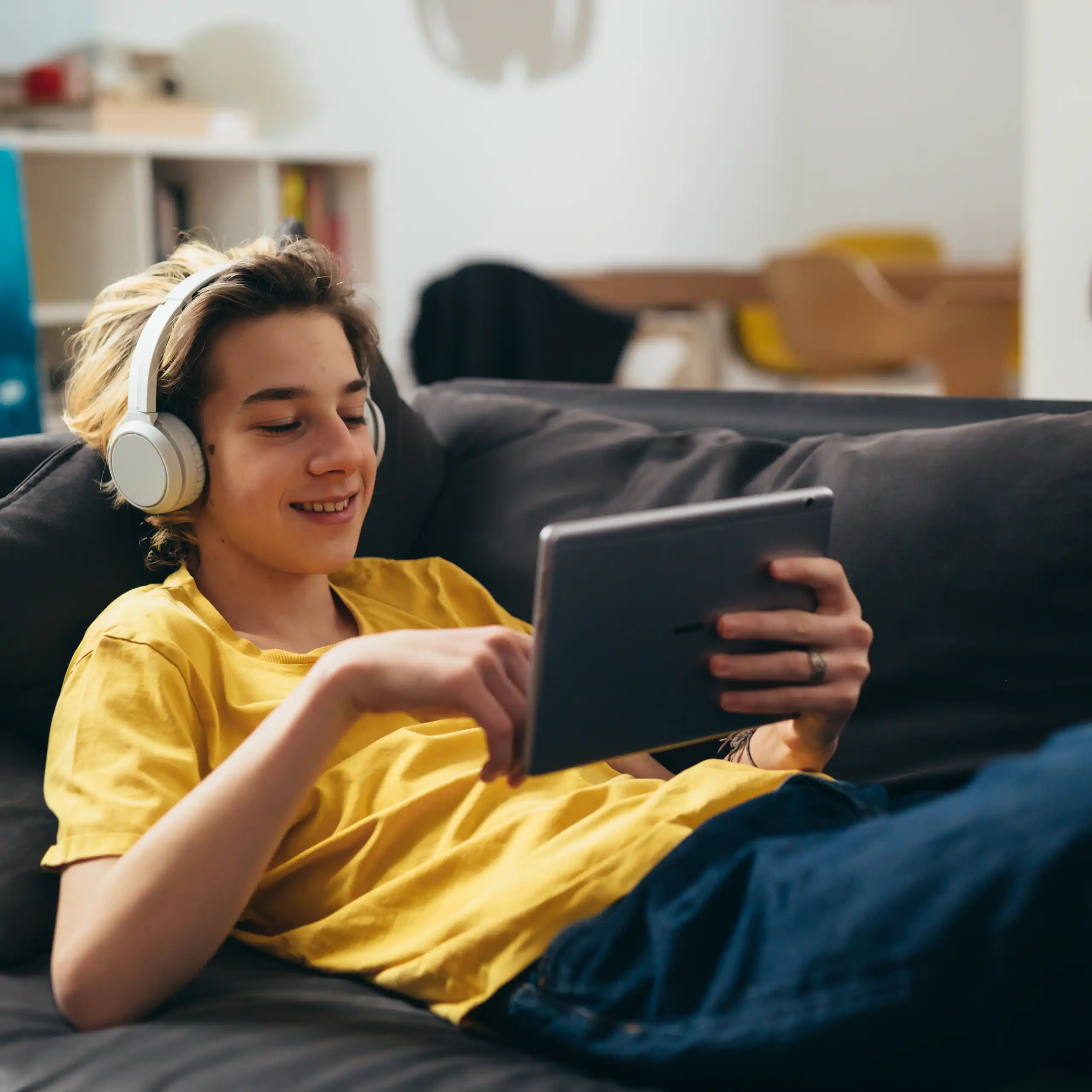 Boy on smiling at tablet