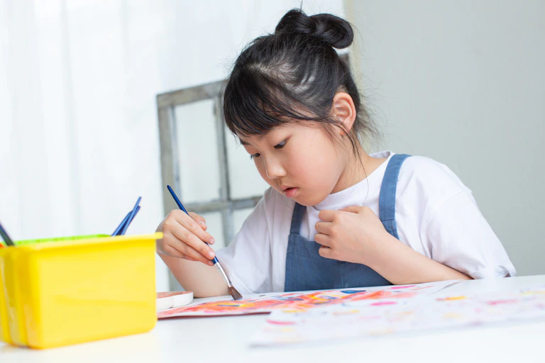 Girl concentrating while painting