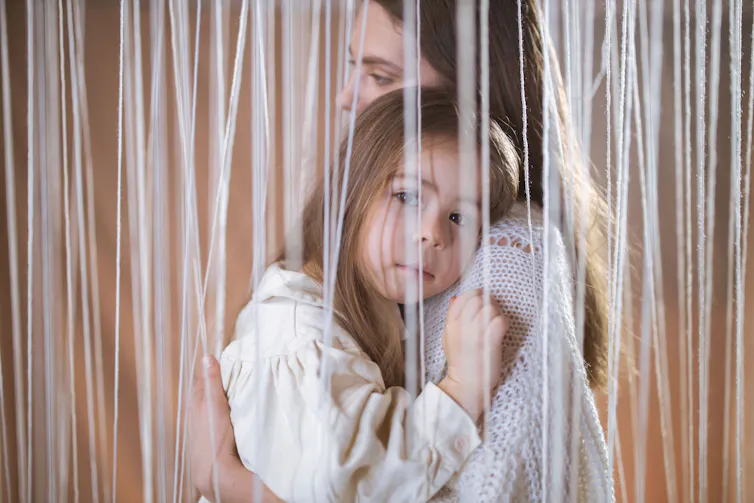 A warm embrace captures the bond between mother and daughter