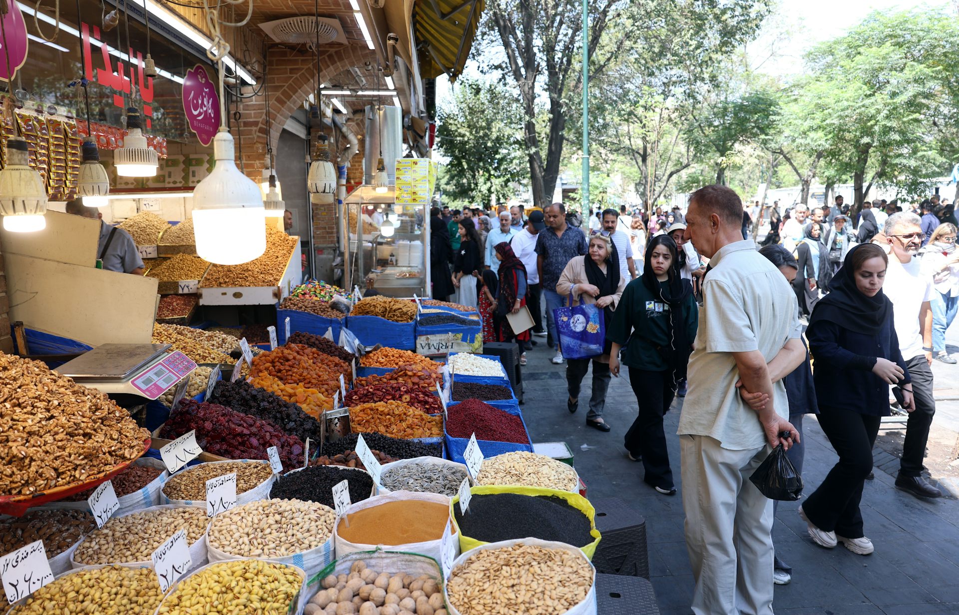 Iranians shop at a bazaar in Tehran, Iran