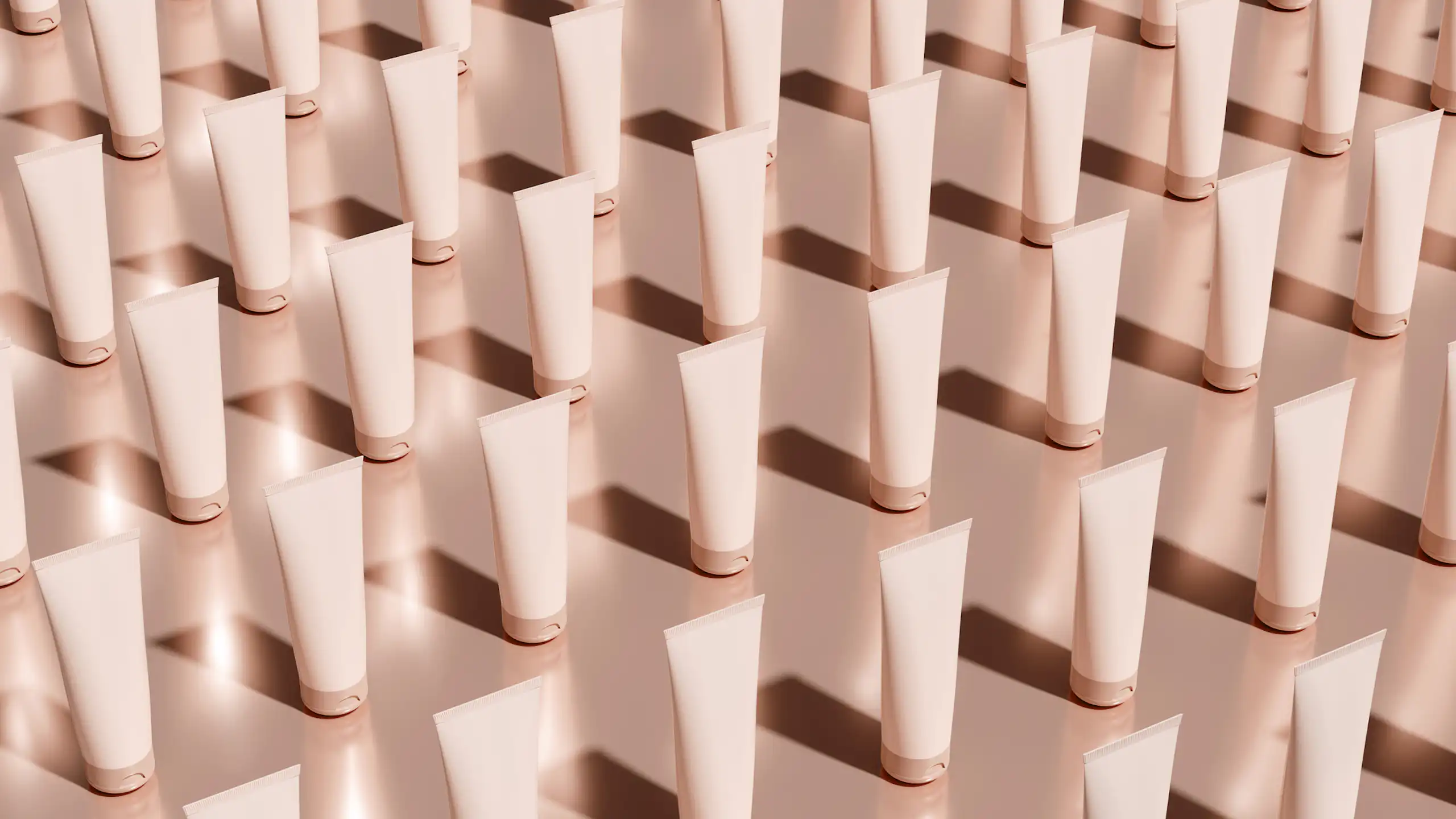 Rows of white or pale pink skincare tubes in diagonal rows