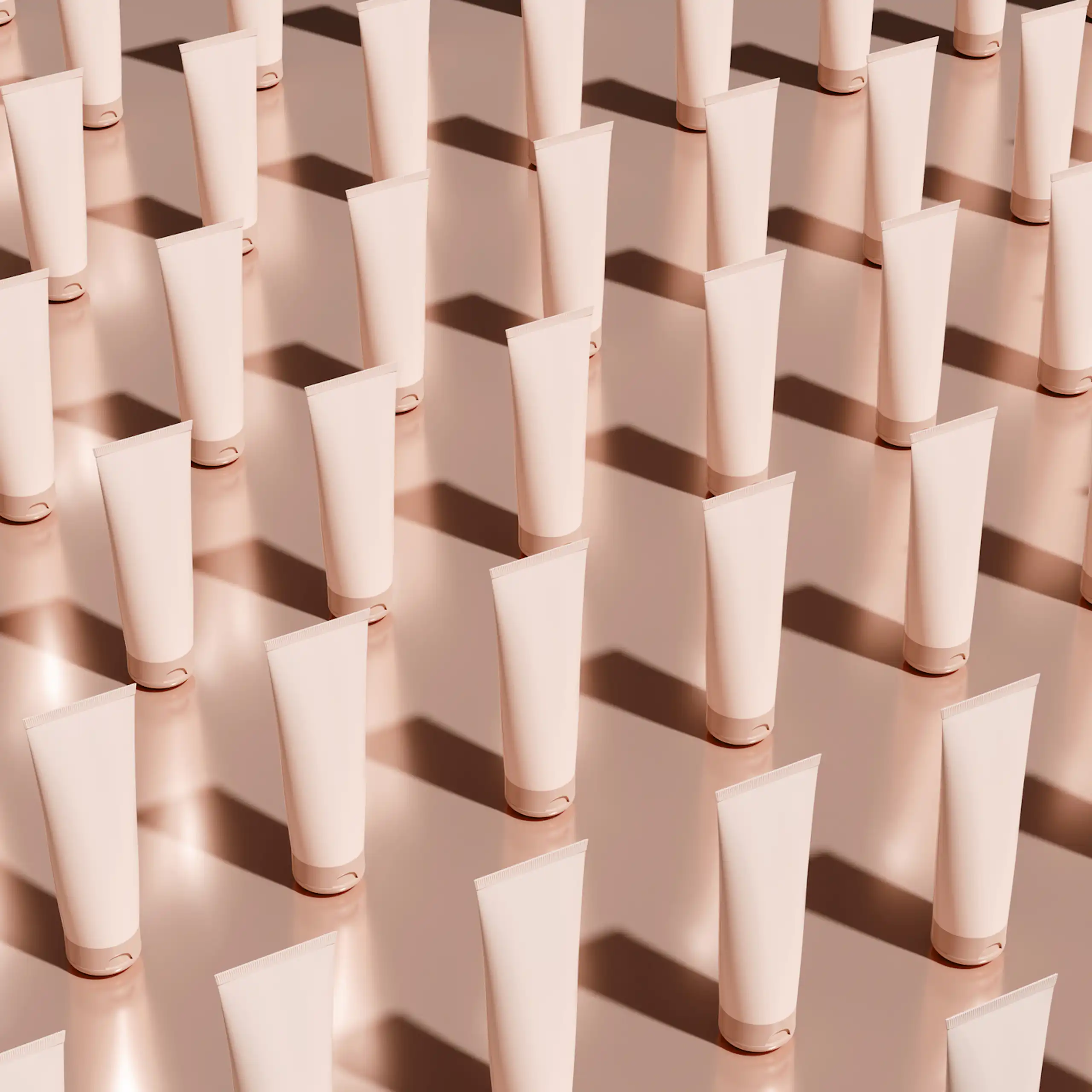 Rows of white or pale pink skincare tubes in diagonal rows