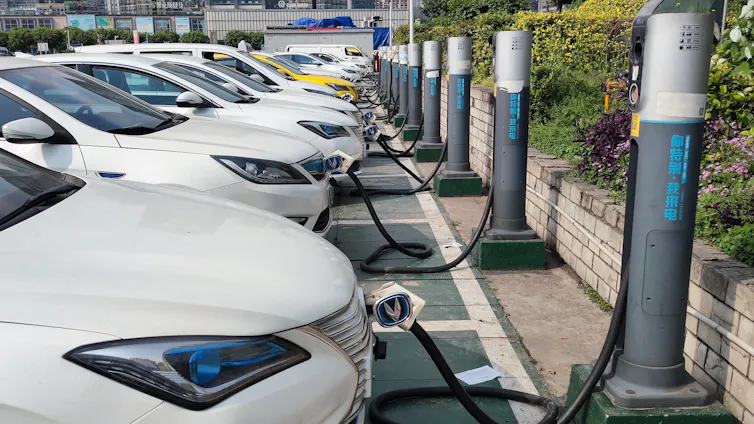 Electric vehicles at charging stations in China.
