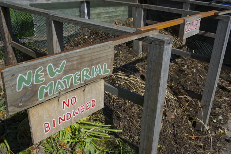 A sign on a wooden frame says 'new material - no bindweed.'