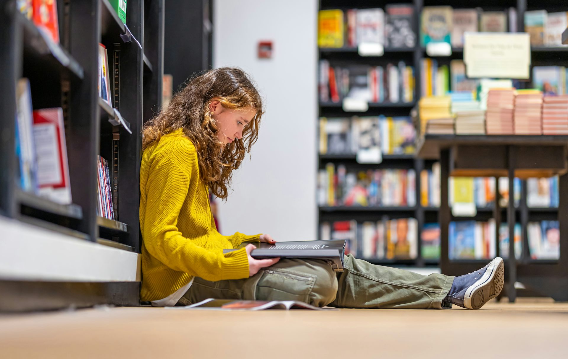 Girl reading in bookstore