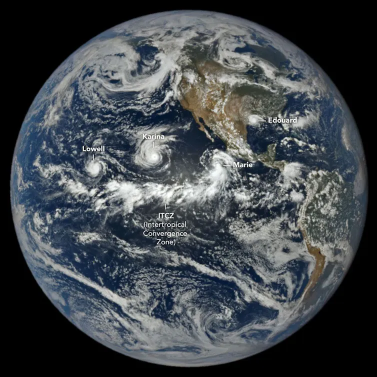A satellite view of Earth showing 3 hurricanes in a row in the Pacific