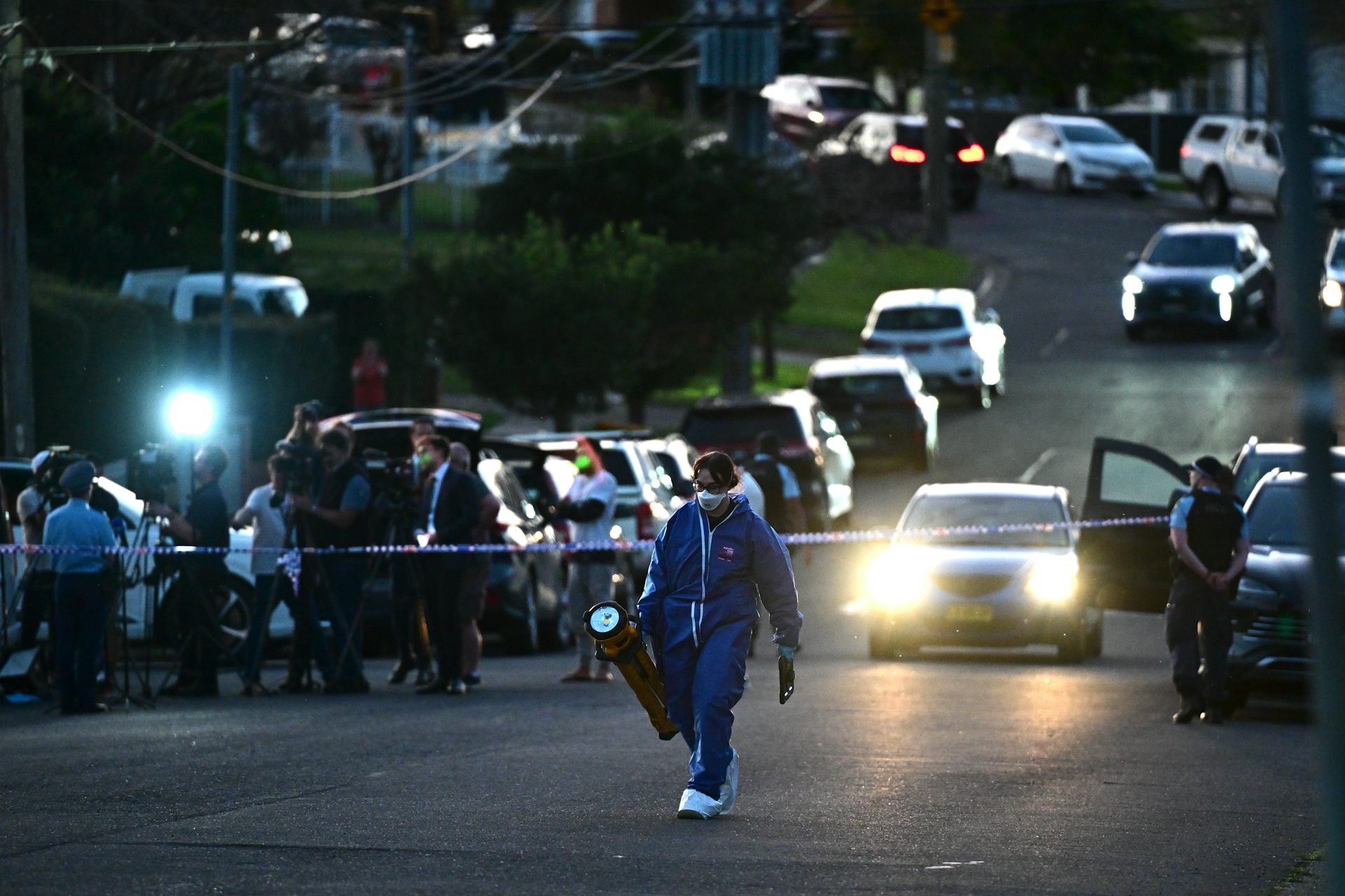 Police detectives, forensics and general duties officers at the scene of a fatal shooting in Sydney.