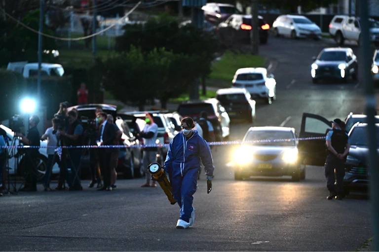 Police detectives, forensics and general duties officers at the scene of a fatal shooting in Sydney.