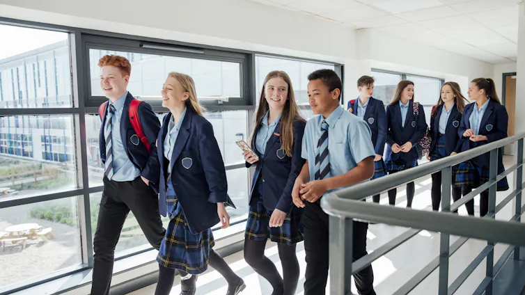 A group of high school students walking to their next class