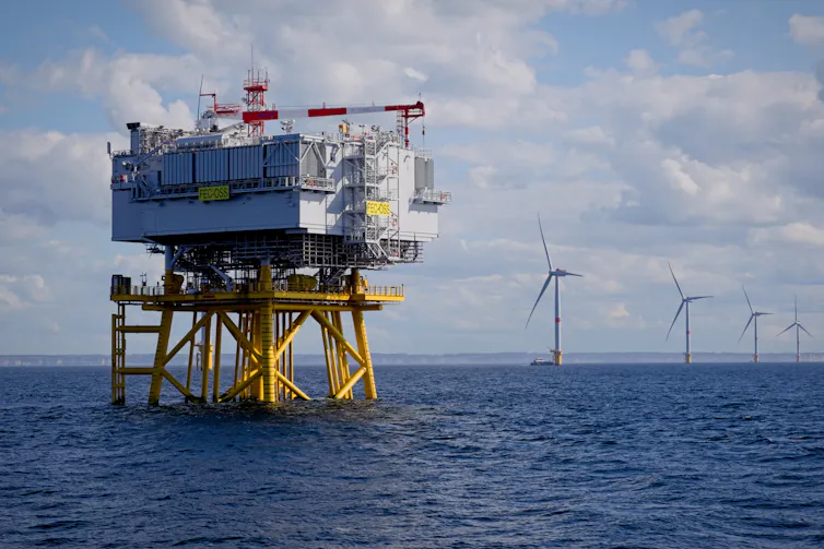 offshore wind substation and wind turbines in sea