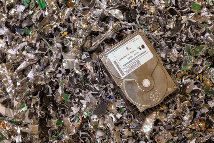 hard drive resting on shredded hard drives