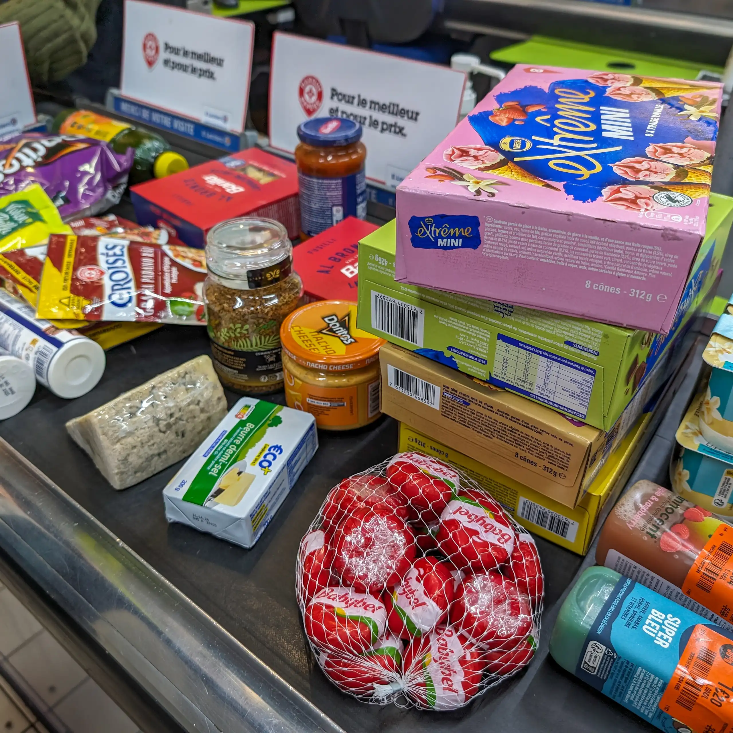 Des produits alimentaires sur un tapis de caisse au supermarché.