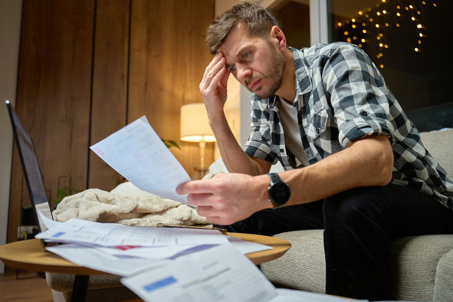 A man looking in concern at bills