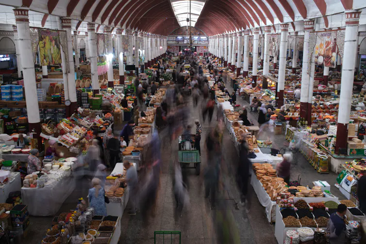 People walk through a bazaar
