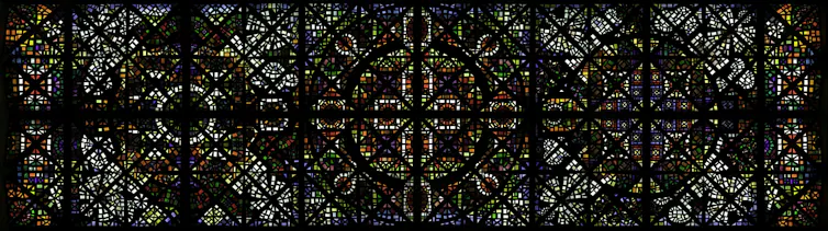 A long rectangular stained-glass ceiling, seen from directly below.