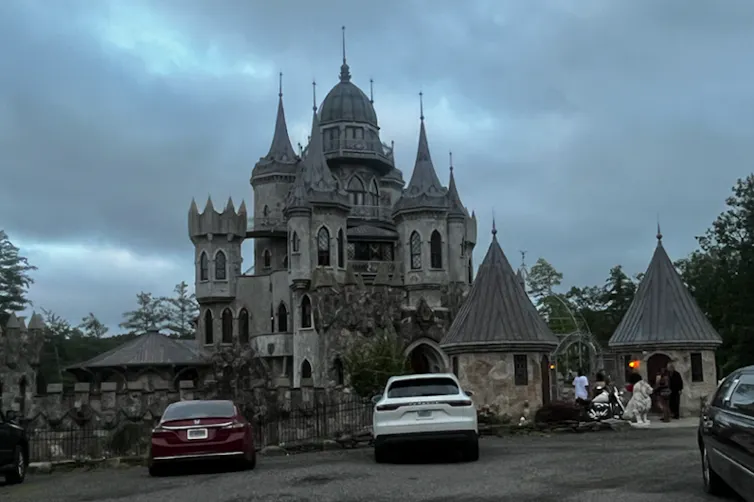 A castle with cars parked in front of it.