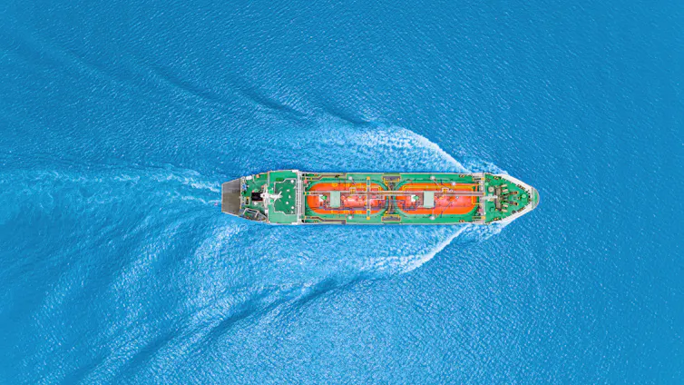 Aerial view of an oil or gas tanker crossing a stretch of the ocean.