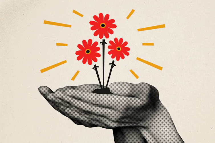 Hands holding illustration of red flowers