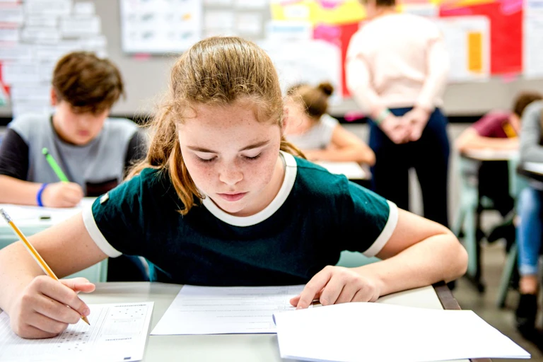 A child writes in class.