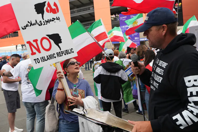 A protester holds a sign that reads No to Islamic Republic