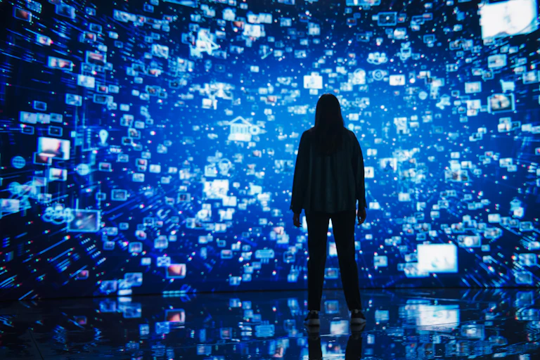 Woman standing in space surrounded by digital screens