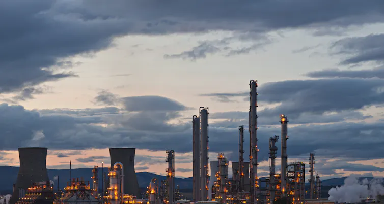 oil refinery, silhouette, cloudy sky