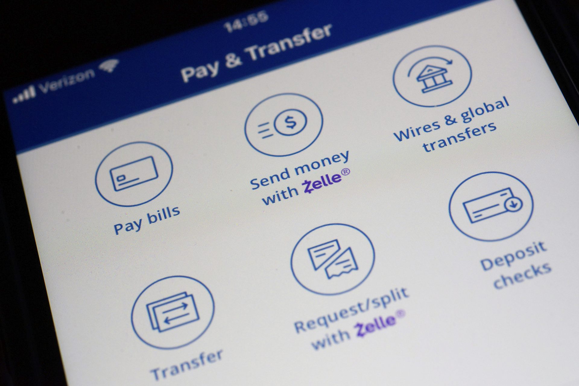 A Zelle payments app displays different options for mobile banking on a smart phone.