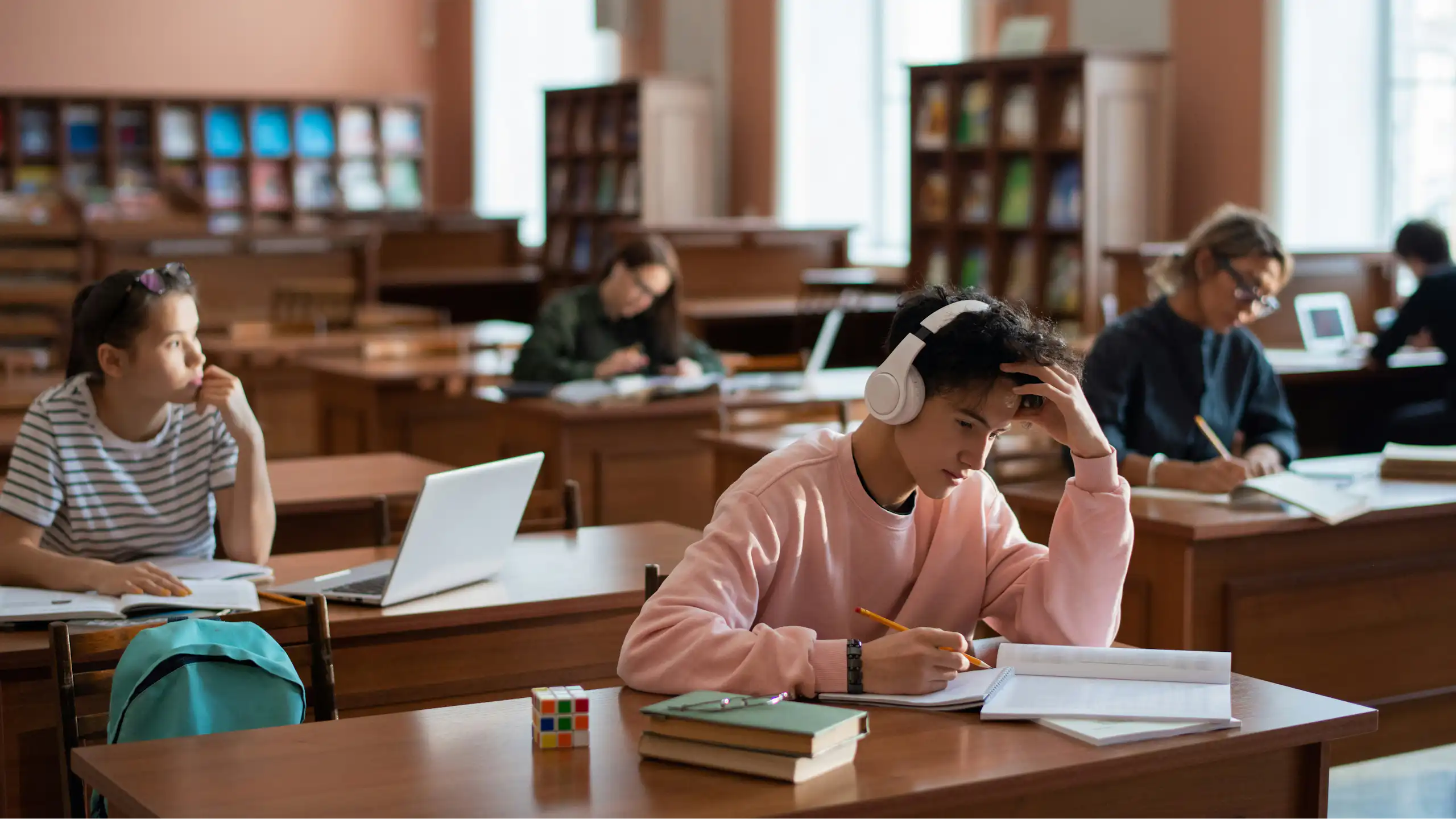 Students work on assignments at desks in classroom
