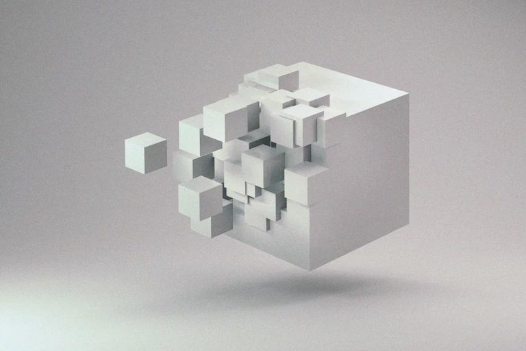 A disintegrating white cube floating in space