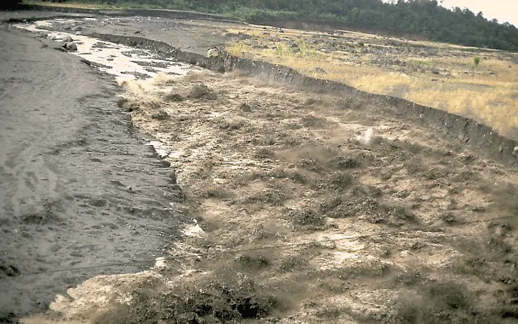 A lahar travels down a river valley in Guatemala near the Santa María volcano, 1989.