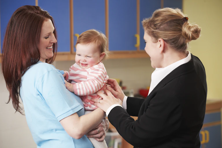 Mother dropping baby off at nursery