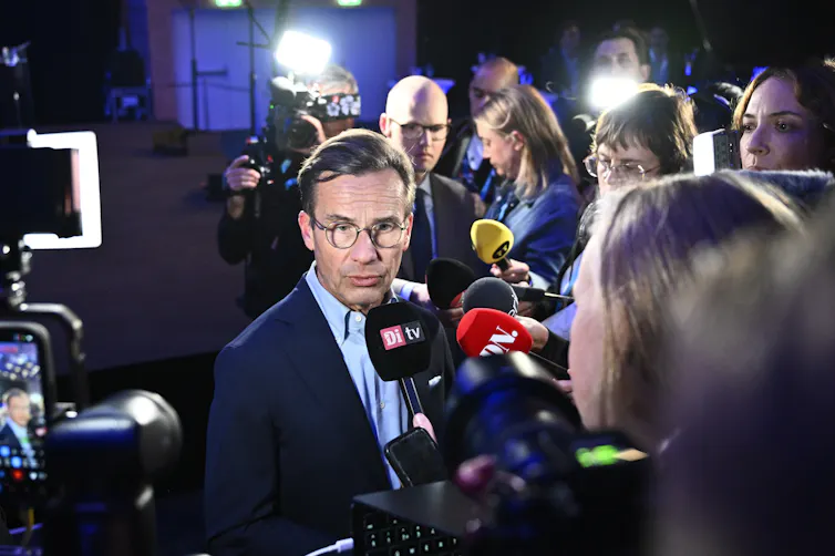 Ulf Kristersson speaks to reporters at an election watch party.