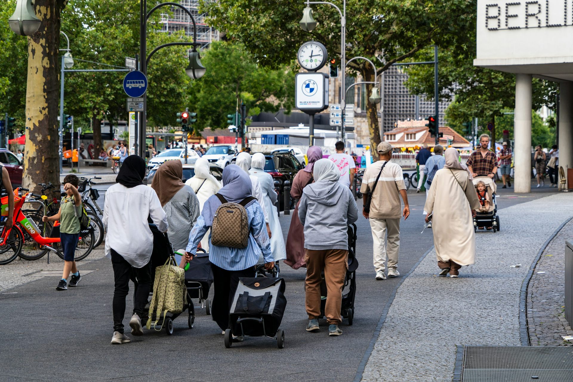 A group of women wearing headscarves walk down the street in Berlin.