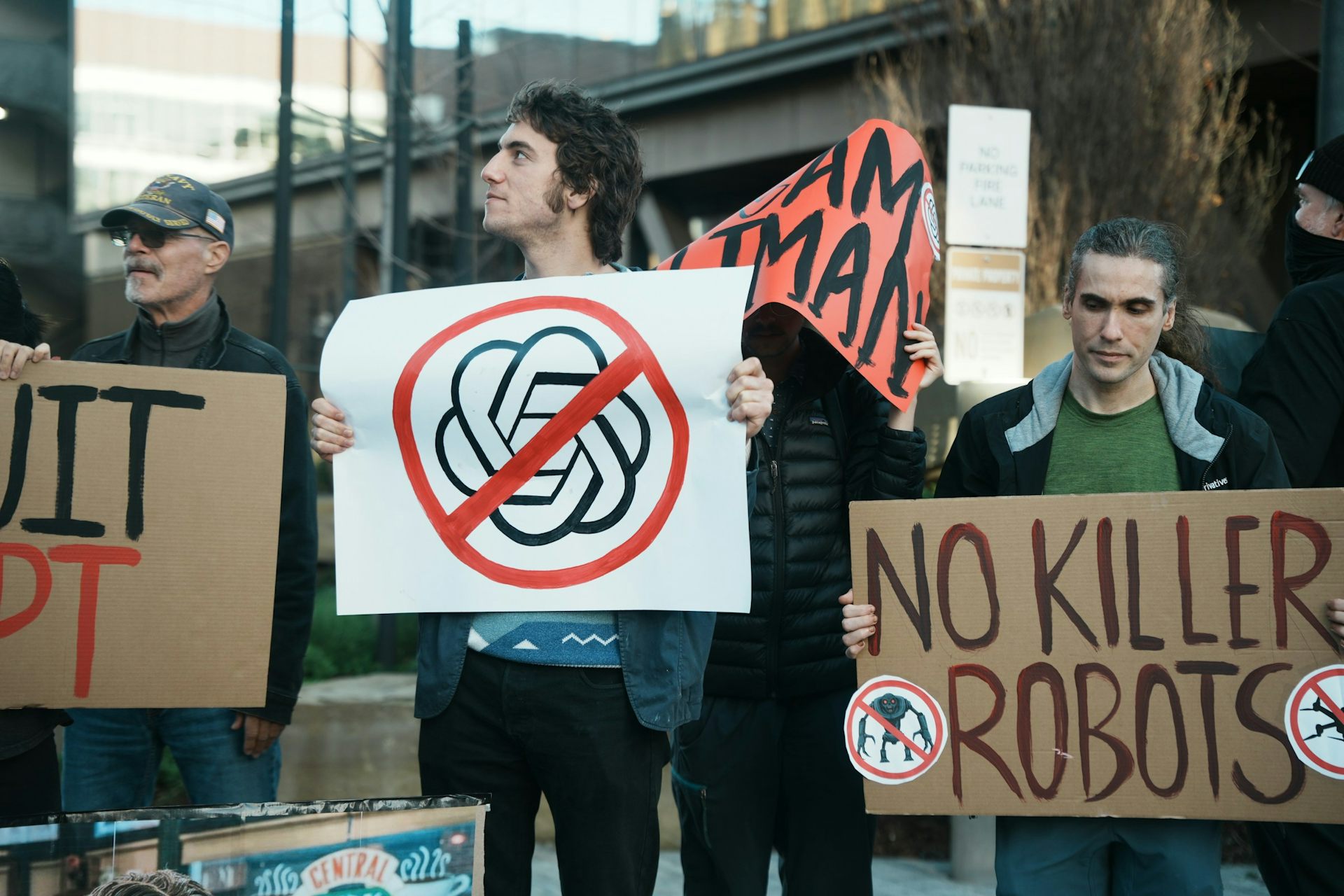 Protesters carry signs such as one stating No Killer Robots.