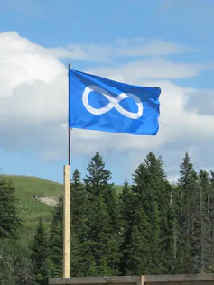 A symbol that looks like a sideways 8 on a flag blowing in the wind.