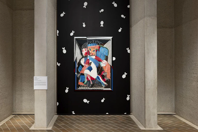 Installation view of a portrait in bright colours, hanging on a black and white patterned gallery wall.