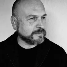 A bald, bearded man.