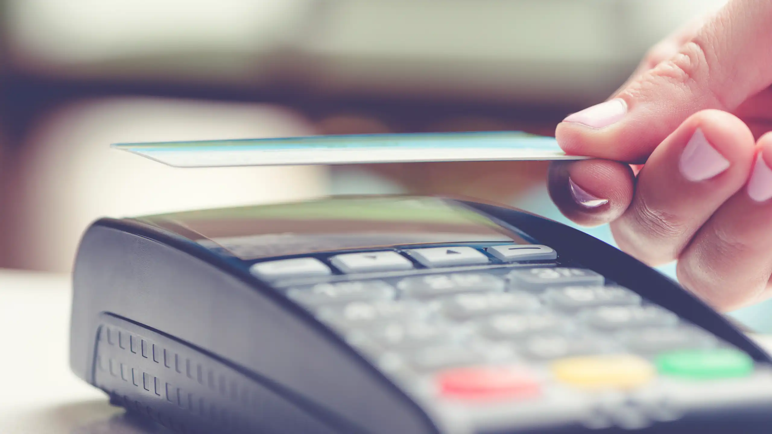 Woman tapping a contactless credit card