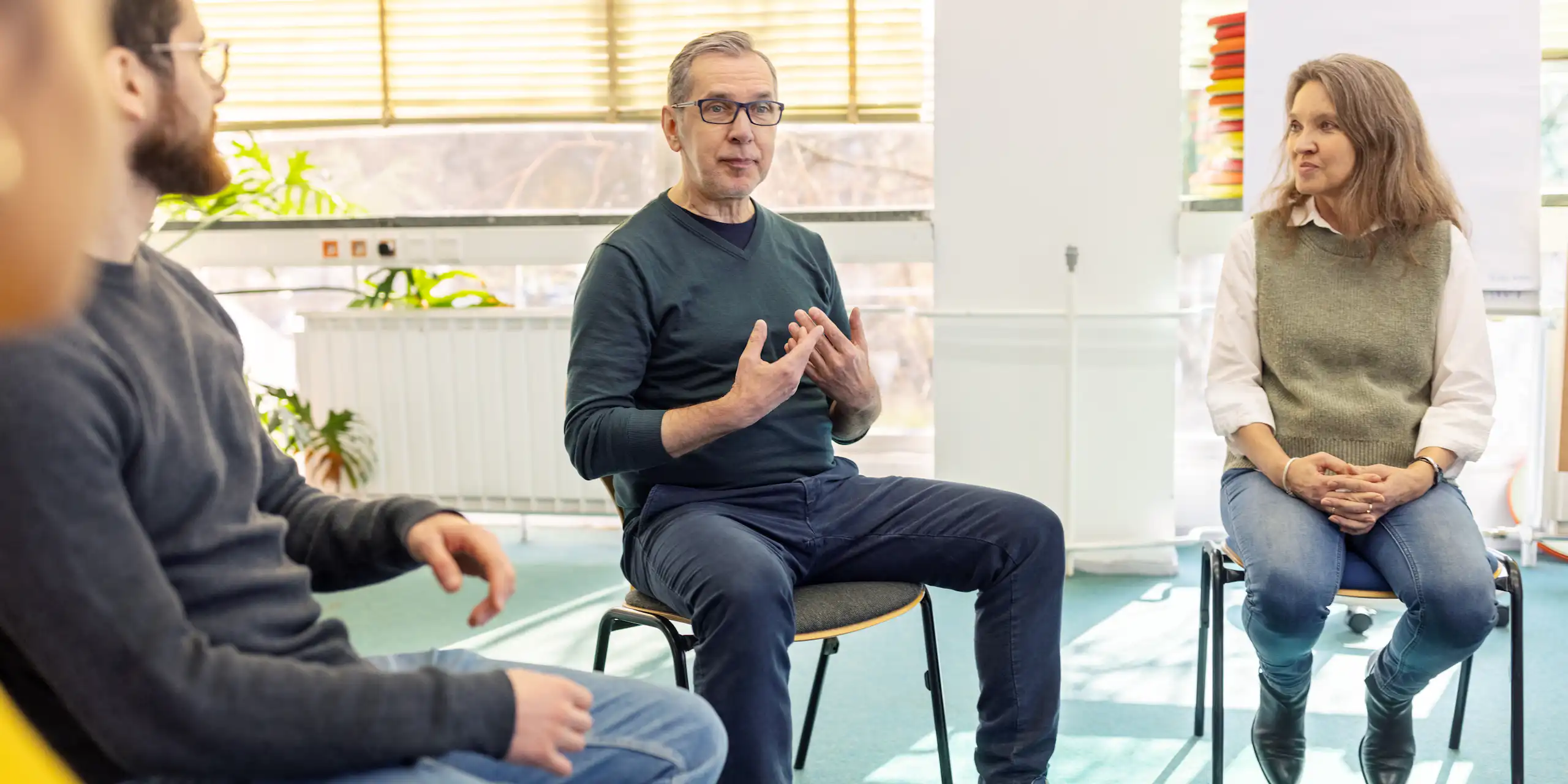 An older man talks about himself in a peer-support session