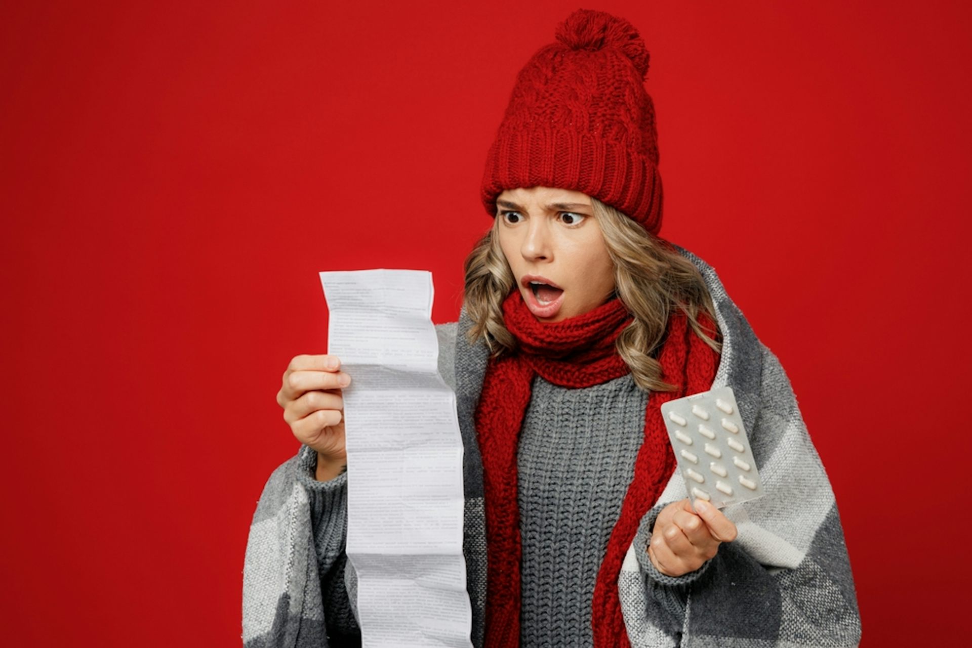 A woman reading a very long list of drug side-effects.