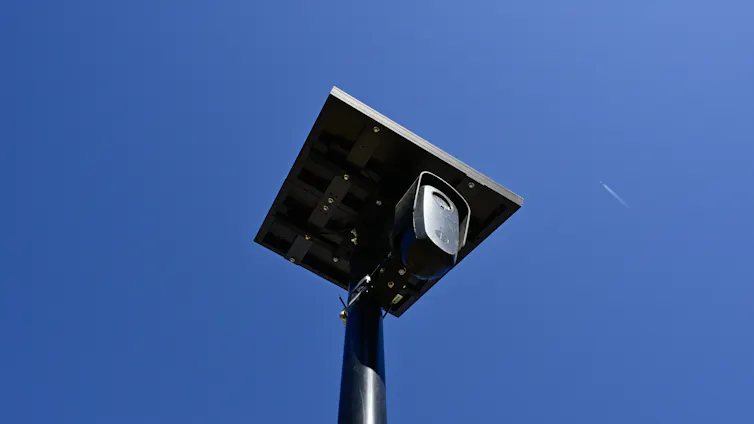A camera on a stand and blue sky.