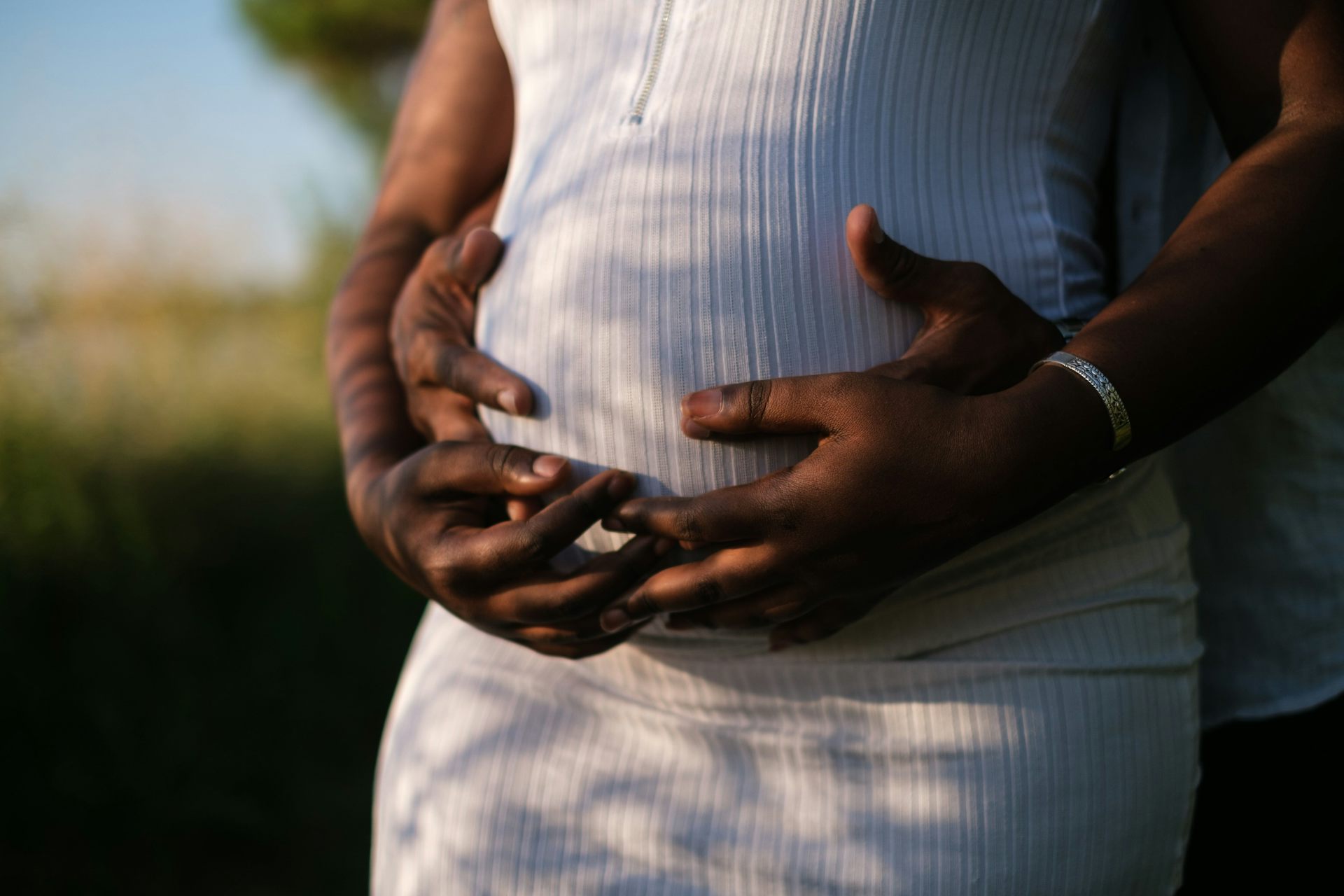 Couple embracing pregnant belly