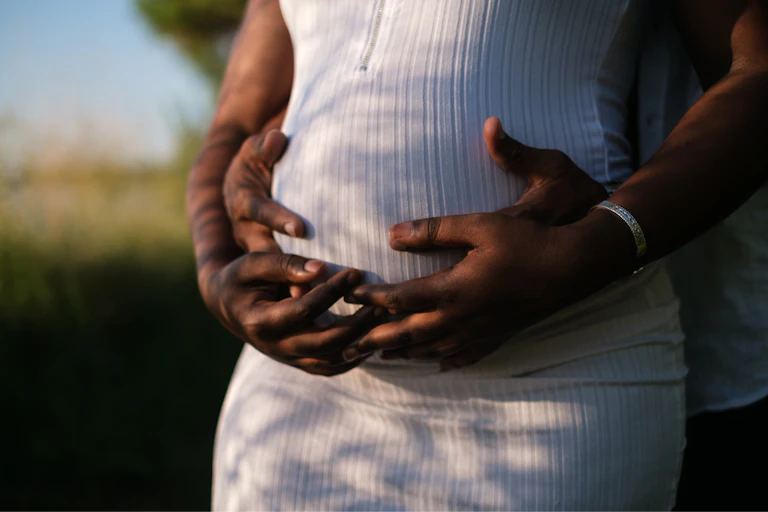 Couple embracing pregnant belly