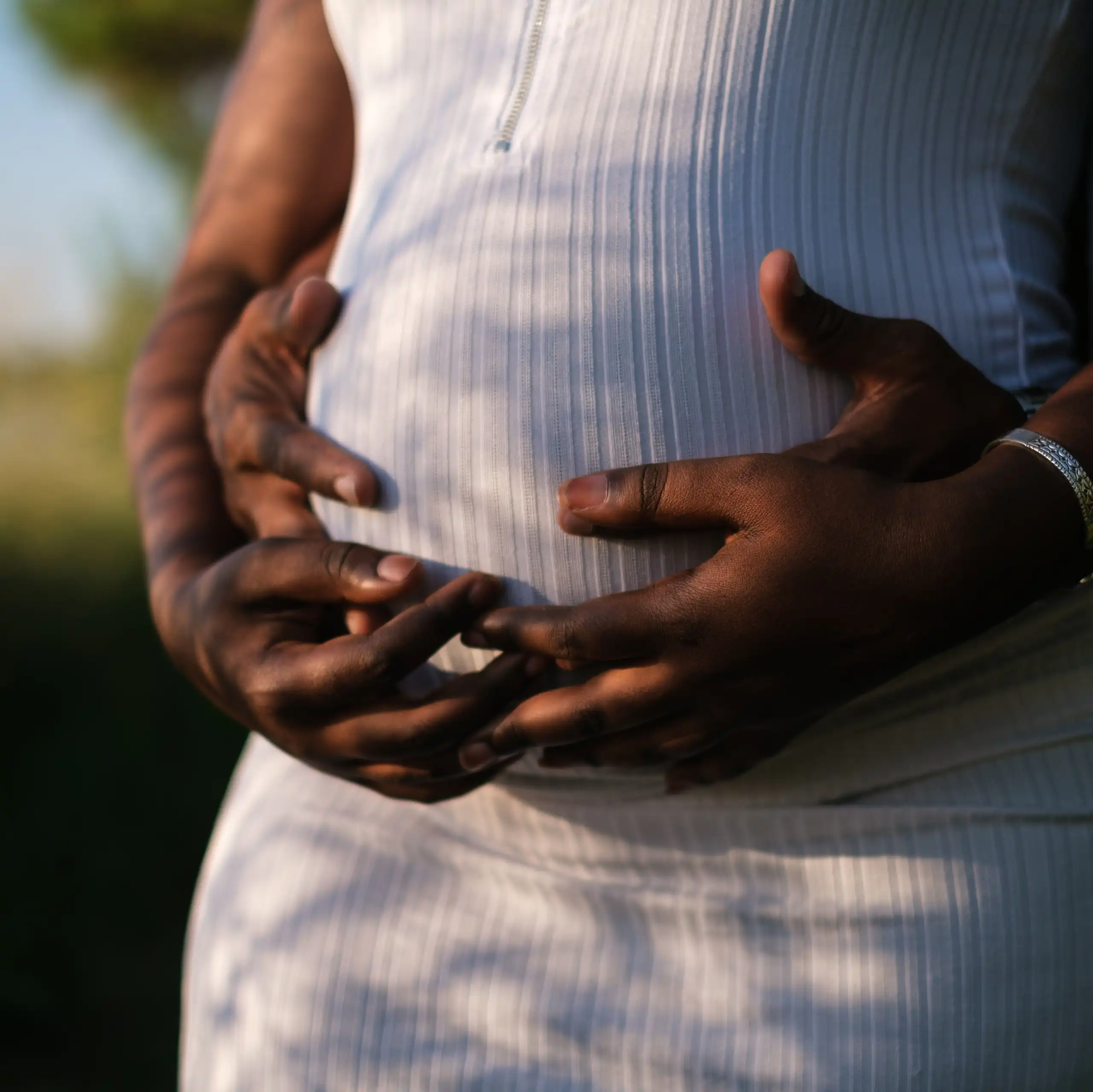 Couple embracing pregnant belly