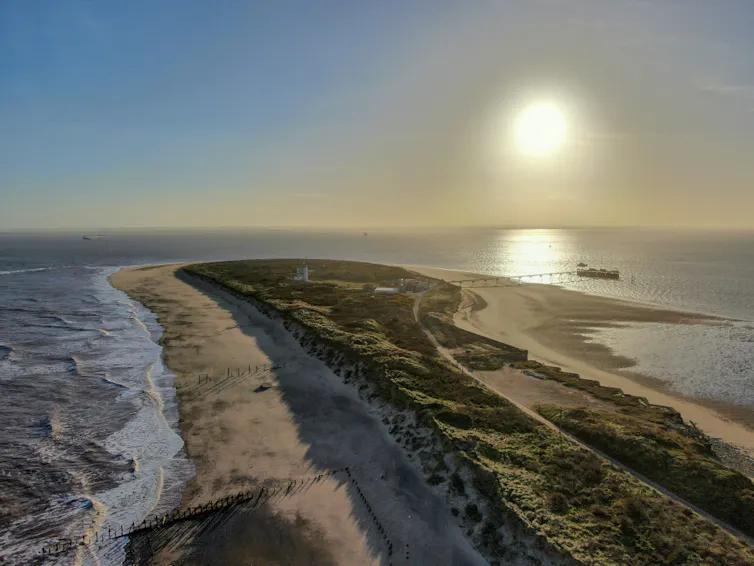 A view from the end of Spurn Point out to sea and against a sunrise